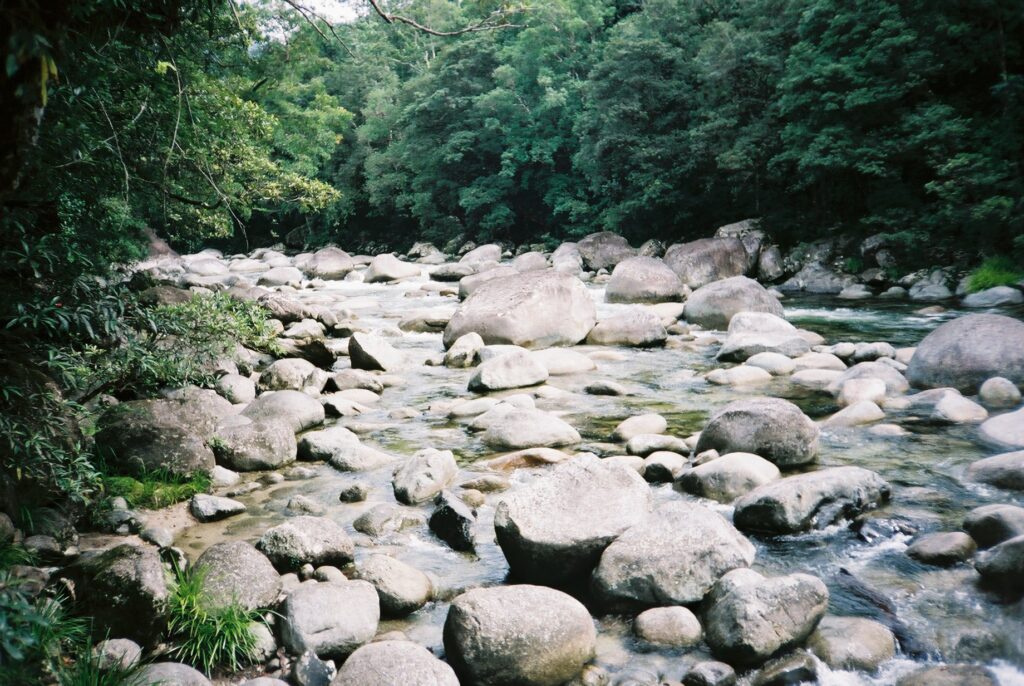 Small boulders and rocks making it difficult to cross a river as a metaphor for obstacles to marketing your translation business